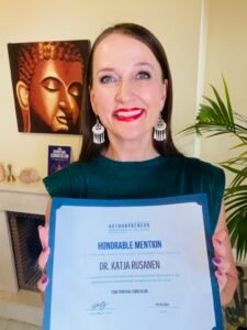 Dr. Katja Rusanen with her book Your Spiritual Curriculum