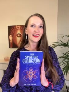 Dr. Katja Rusanen with her book Your Spiritual Curriculum