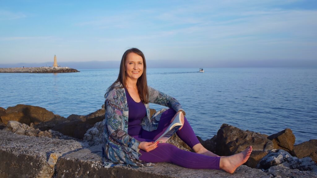 Dr. Katja Rusanen with her book Your Spiritual Curriculum